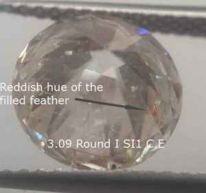 Clarity enhancement red hue of the filler, bottom in a round diamond